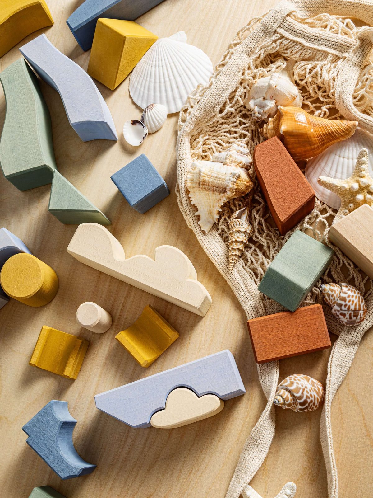 Colorful wooden pieces of the Byron lighthouse Puzzle on a wooden surface, designed for imaginative play.