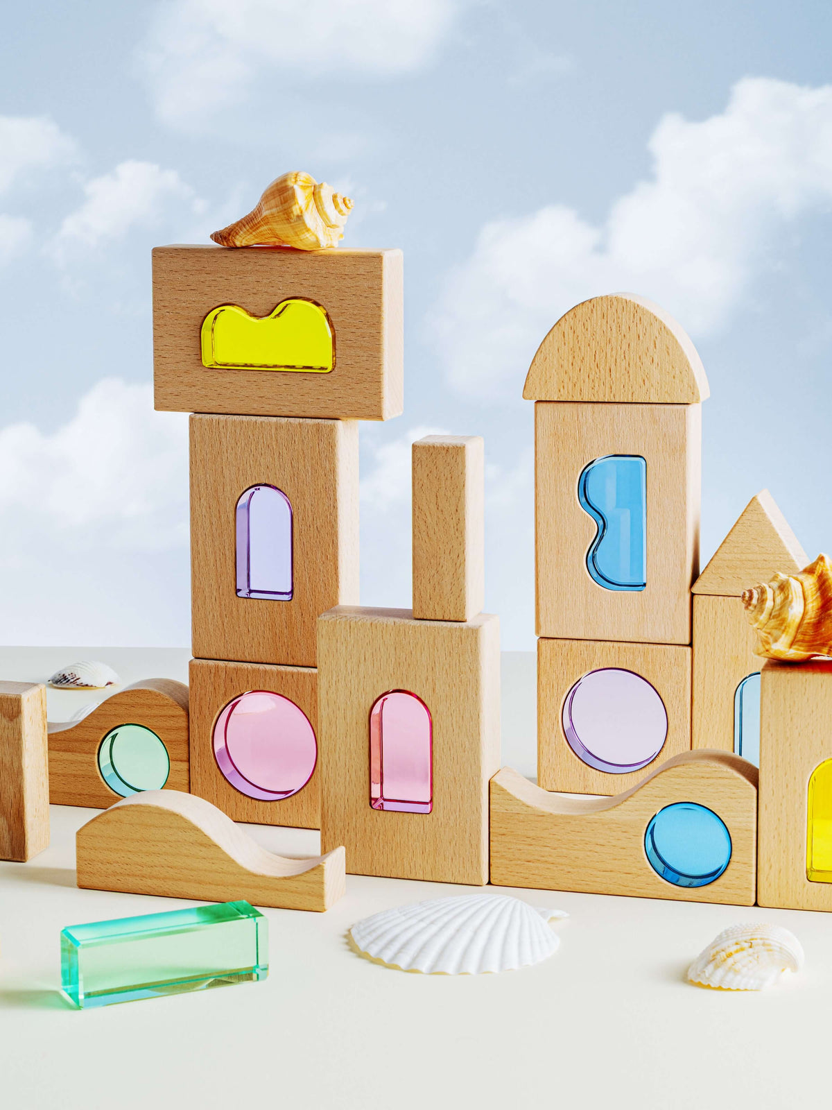 Laguna Block Set showcasing natural beechwood and colorful acrylic pieces against a sky backdrop.