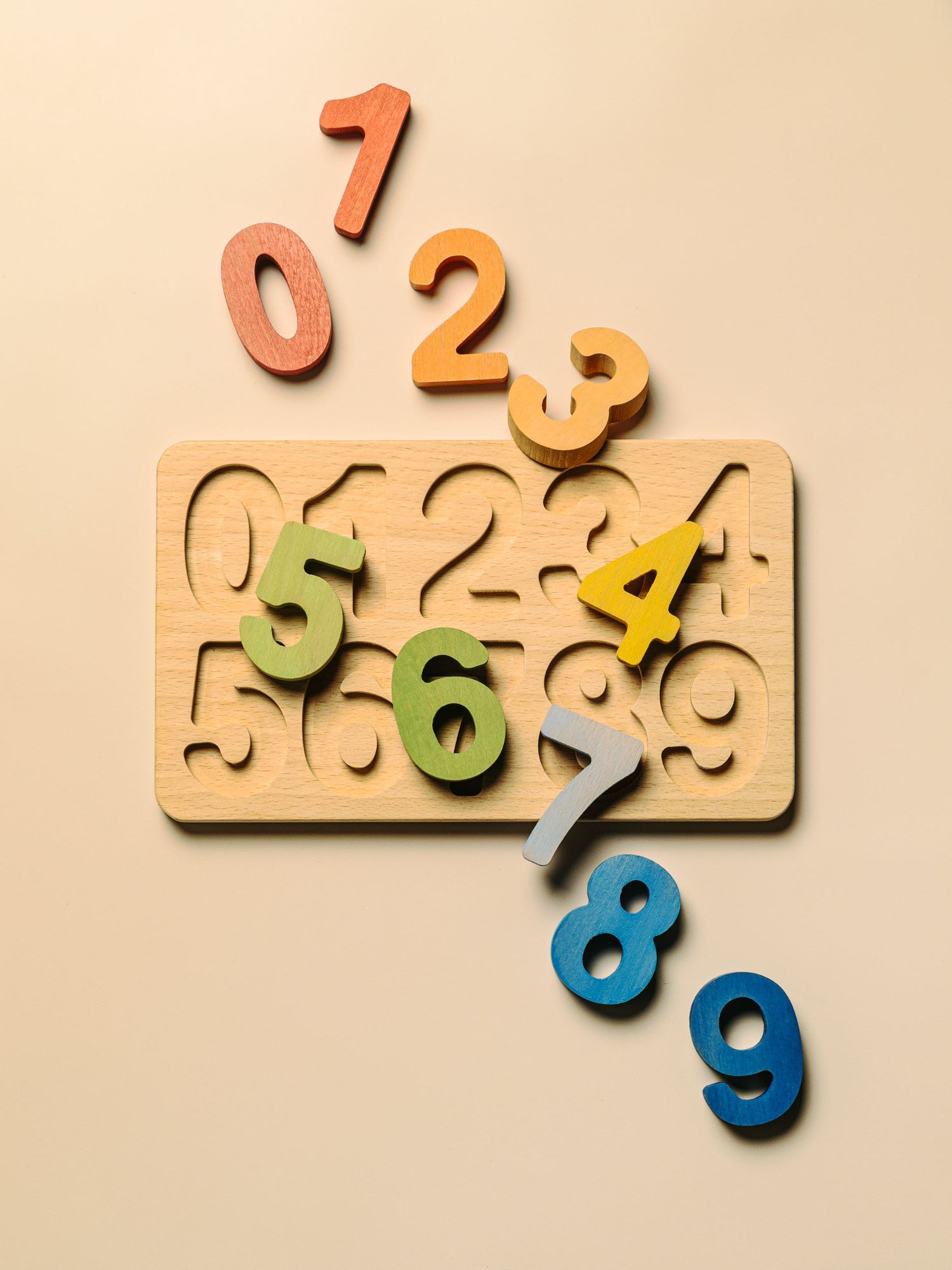 Colorful wooden educational puzzle set featuring numbers 0-9 on a light background.