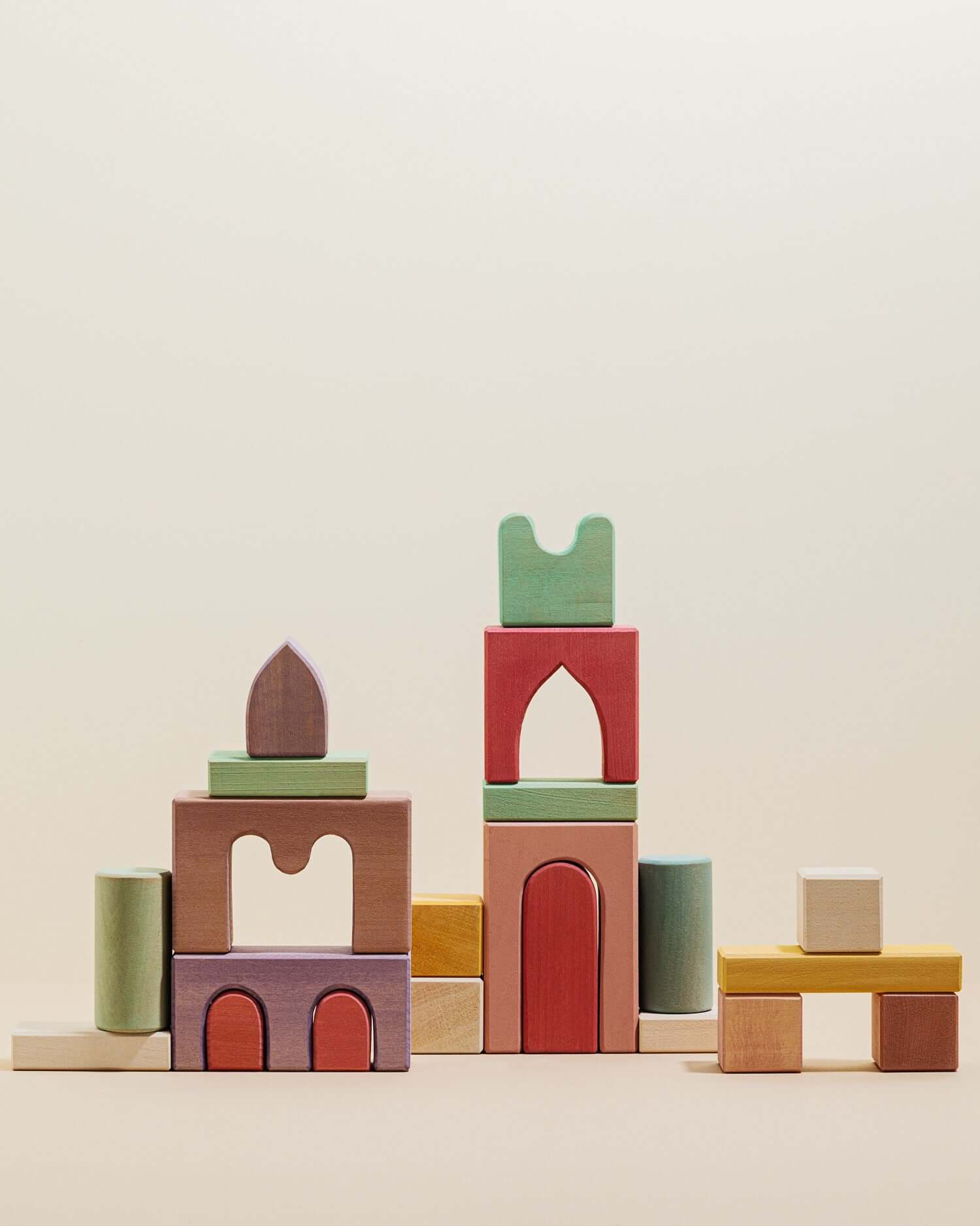 Karen Building Blocks lime wood set stacked into colorful castle towers with arches and tunnels, non-toxic stained blocks