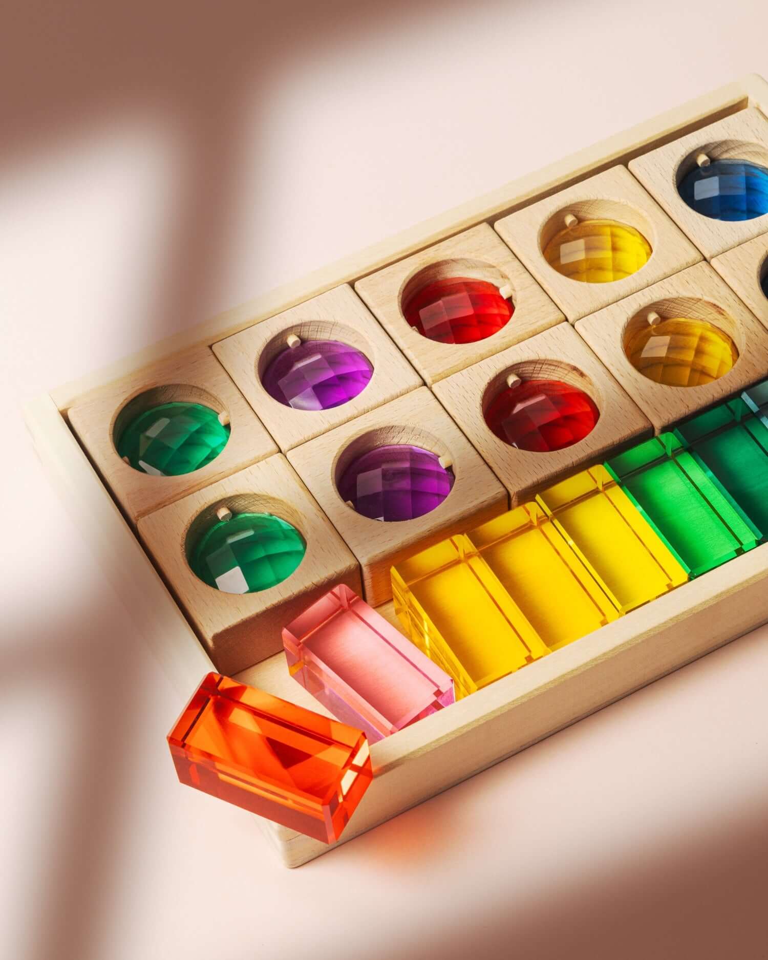 James Block Set translucent wooden blocks with colorful lucite gemstones and windows creating light and shadow play