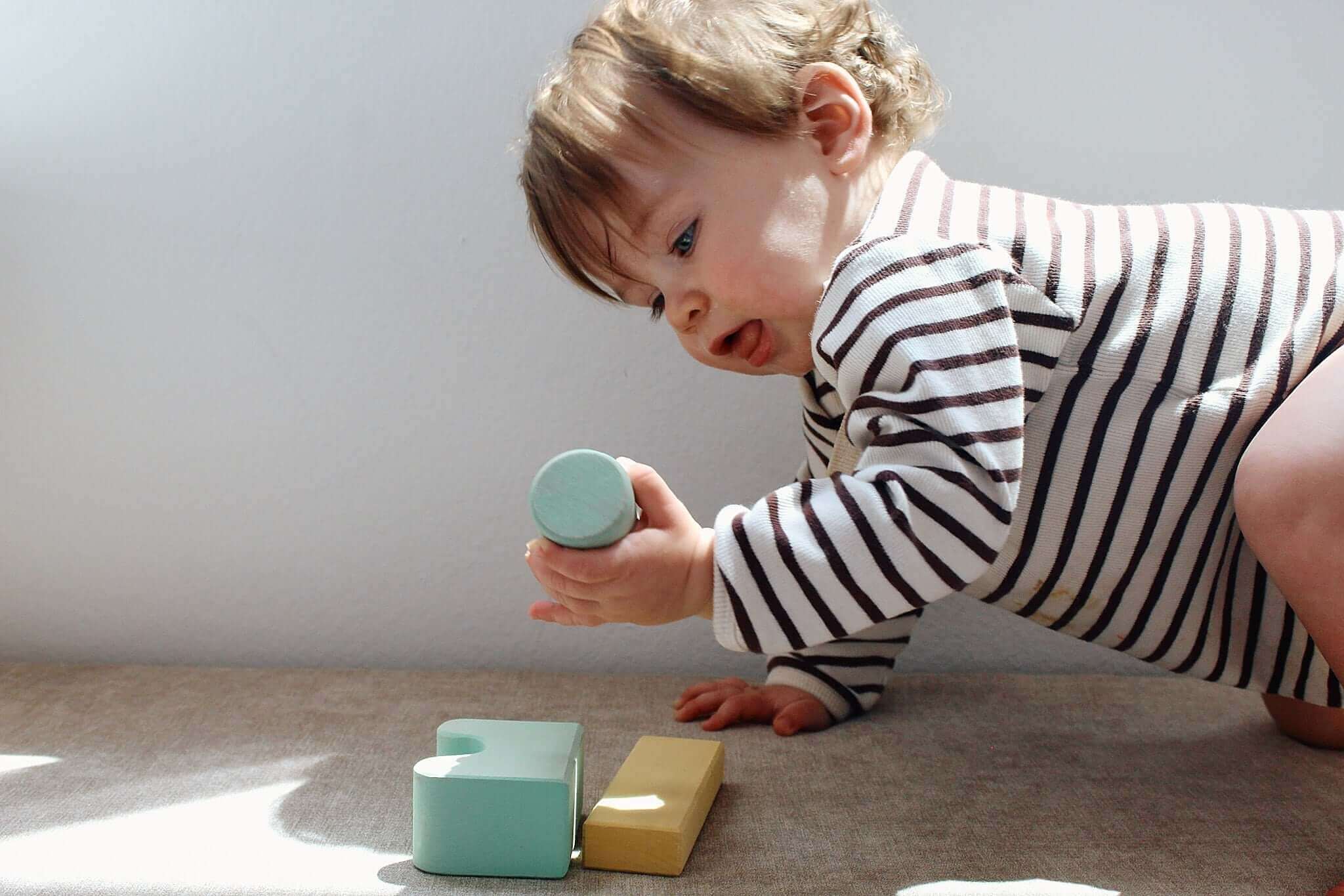 fine motor skills activity for toddlers using wooden blocks