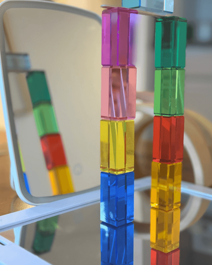 Colorful building blocks arranged in reflection for Reflection STEM Activity for Kids, exploring symmetry and light.