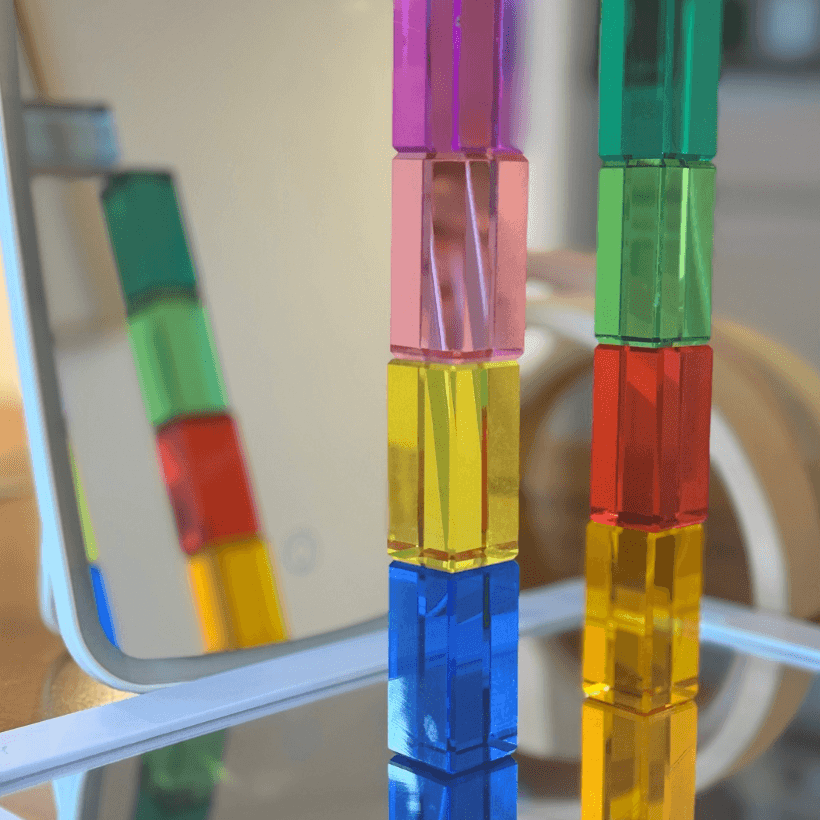 Colorful building blocks arranged in reflection for Reflection STEM Activity for Kids, exploring symmetry and light.