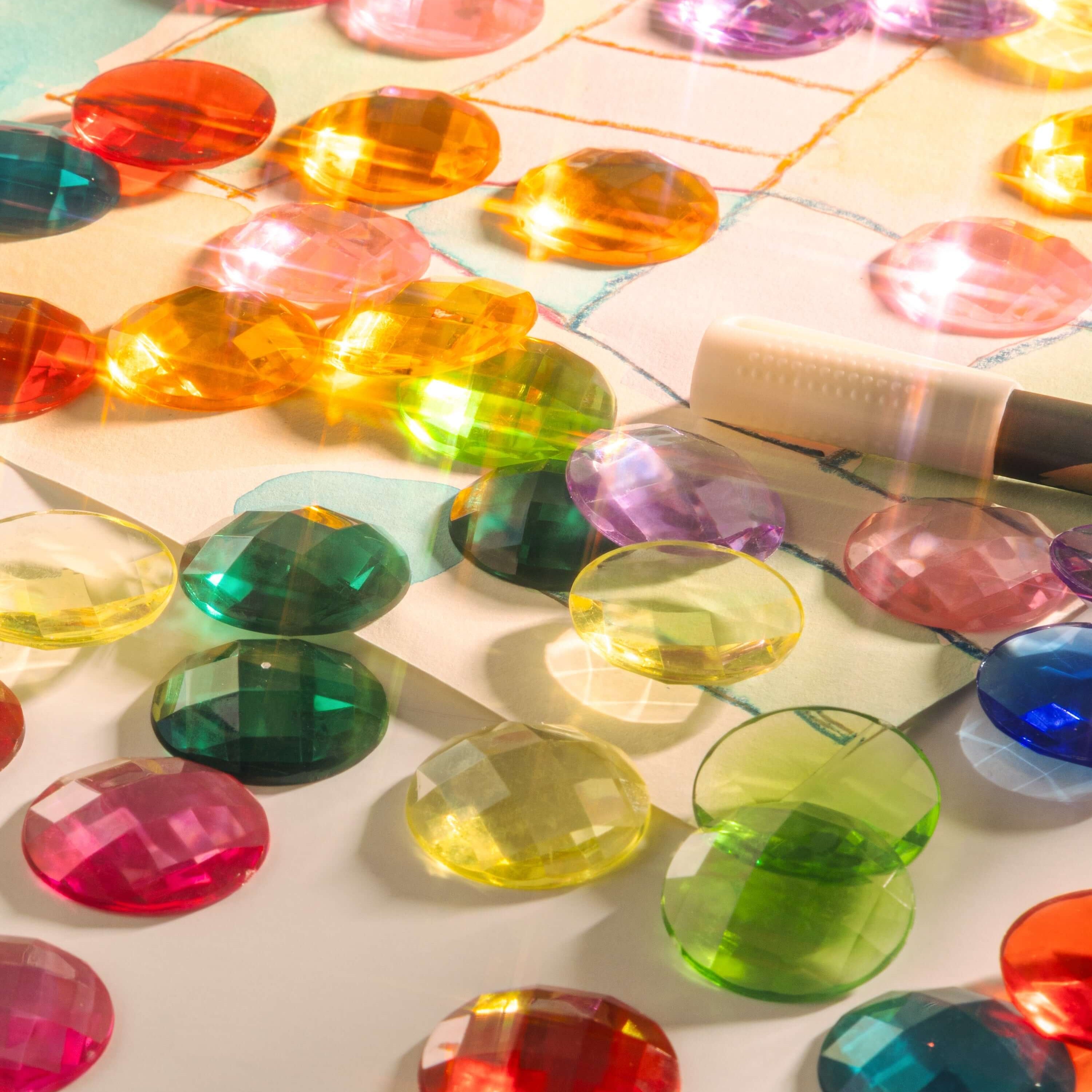 Colorful sensory gems scattered on a surface, showcasing how Sensory Gems Support Early Development.
