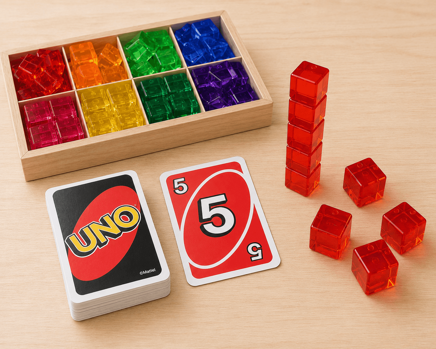 Preschool math game with Uno cards and Ines blocks, featuring colorful blocks and Uno cards on a wooden table.