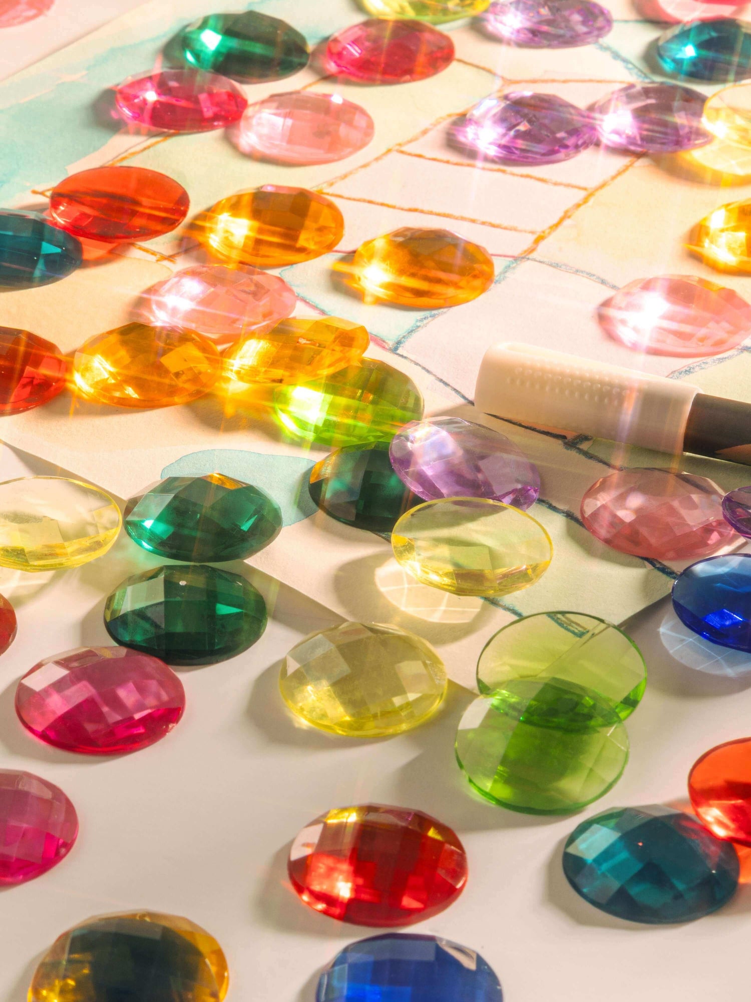 Colorful sensory gems scattered on a surface, showcasing how Sensory Gems Support Early Development.