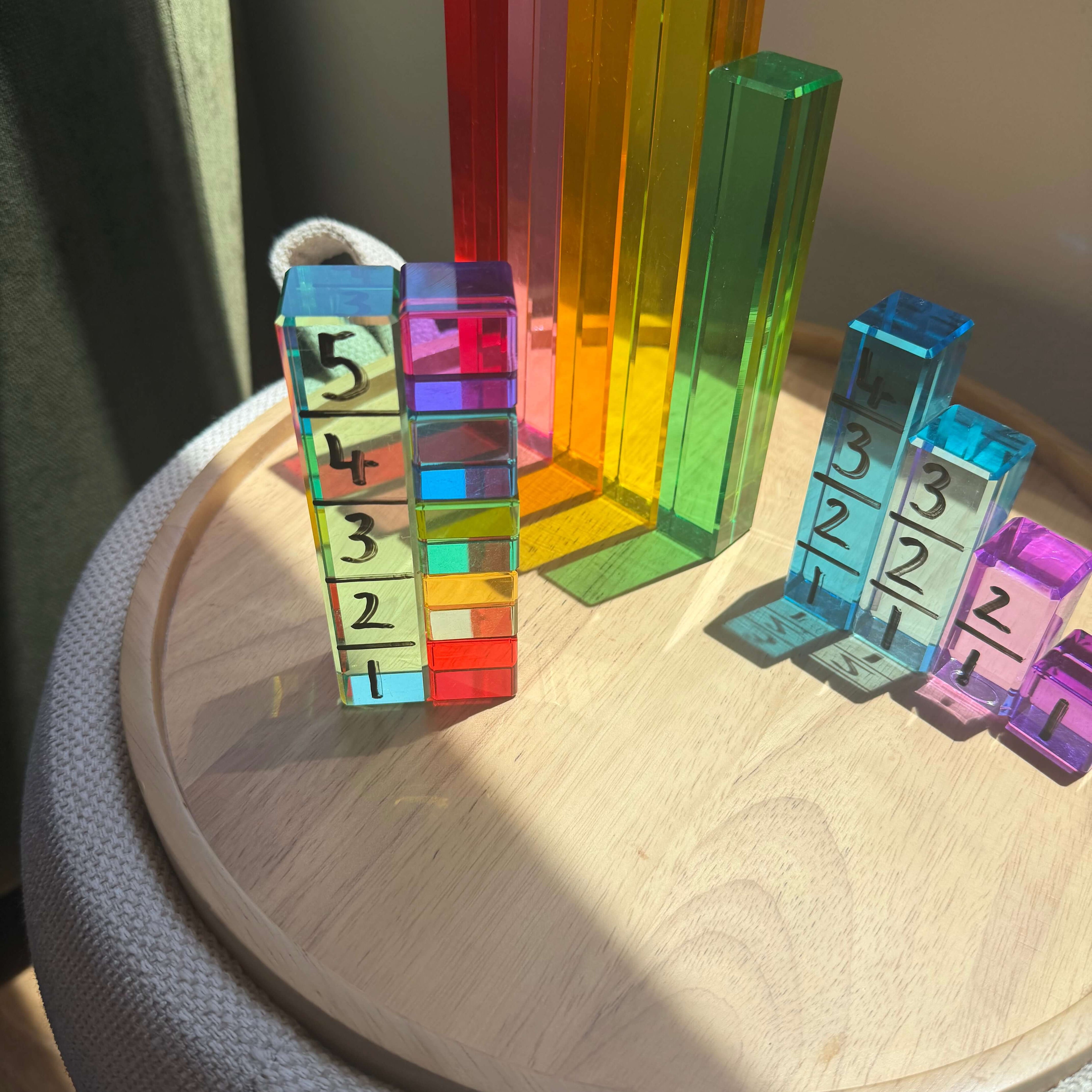 Colorful unit blocks arranged on a side table for a Unit Block Activity for Toddlers.
