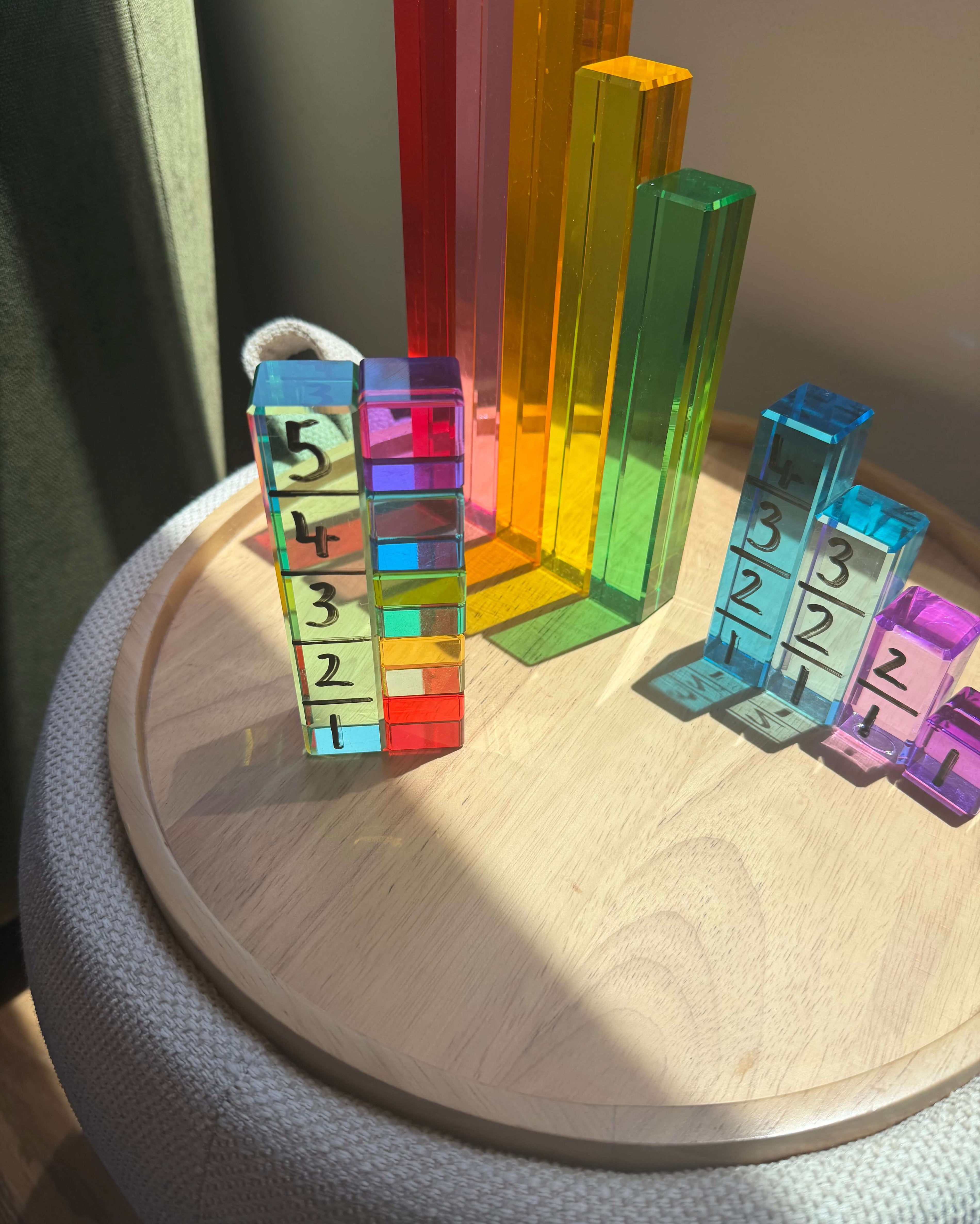Colorful unit blocks arranged on a side table for a Unit Block Activity for Toddlers.