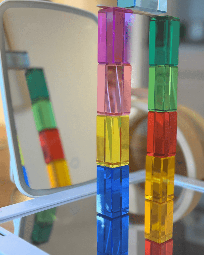 Colorful building blocks arranged in reflection for Reflection STEM Activity for Kids, exploring symmetry and light.
