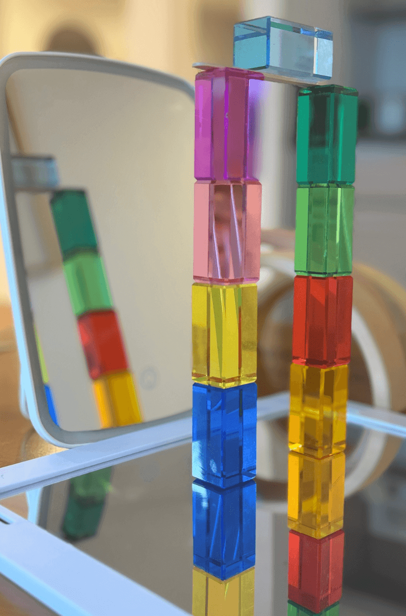 Colorful building blocks arranged in reflection for Reflection STEM Activity for Kids, exploring symmetry and light.