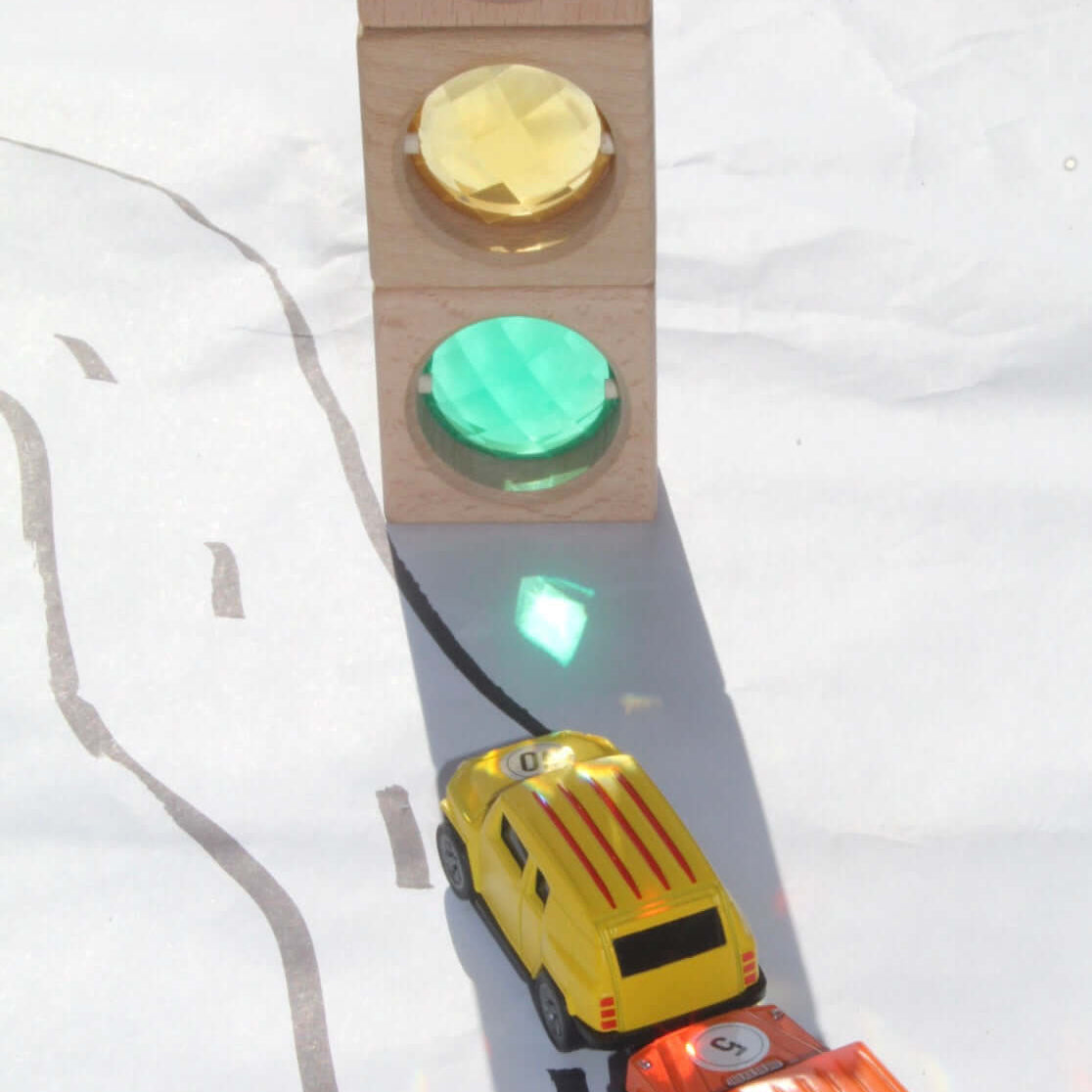 Maison Rue translucent blocks casting colored shadows on toy cars