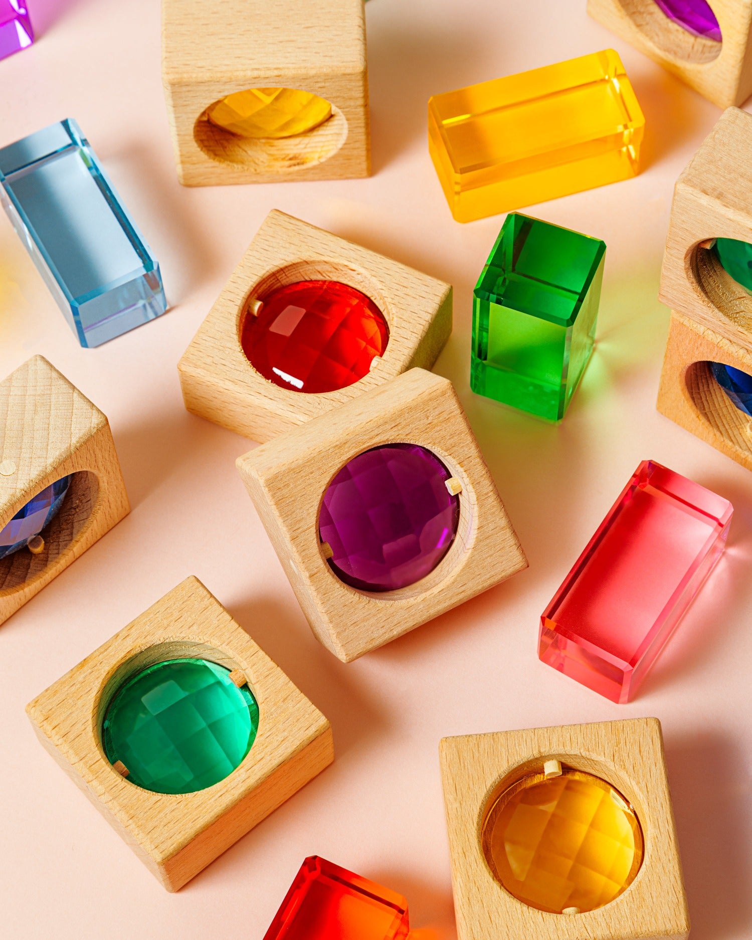 Wooden gem blocks with colorful gems for sensory play and Montessori learning.