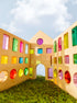 Rêve House Set modular wooden building set creating a colorful architectural structure under a blue sky.