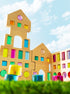 Colorful wooden blocks forming a building design in the grand building collection set against a blue sky.