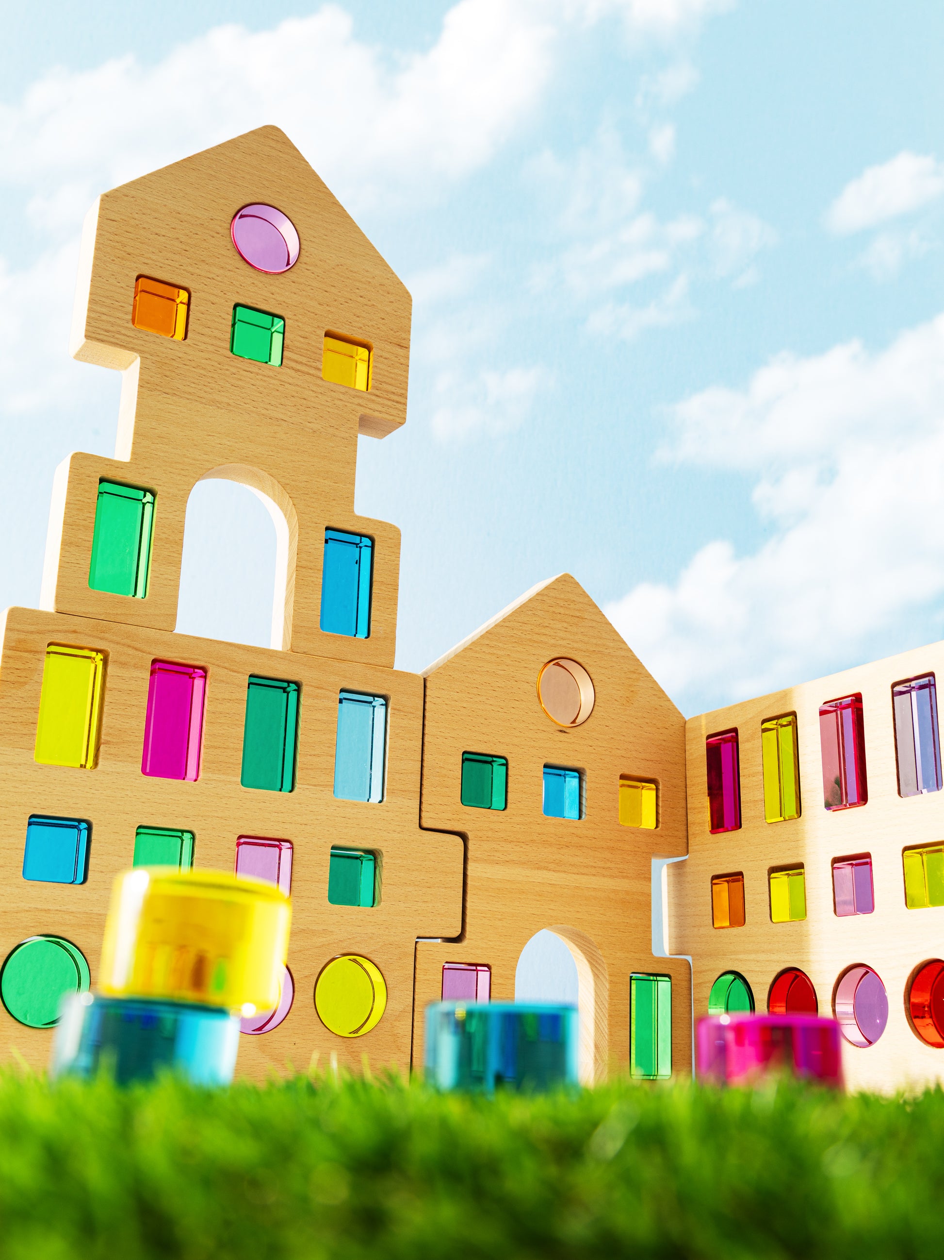 Colorful wooden blocks forming a building design in the grand building collection set against a blue sky.