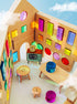 Rêve House Set modular wooden building set interior showcasing colorful windows and furniture.
