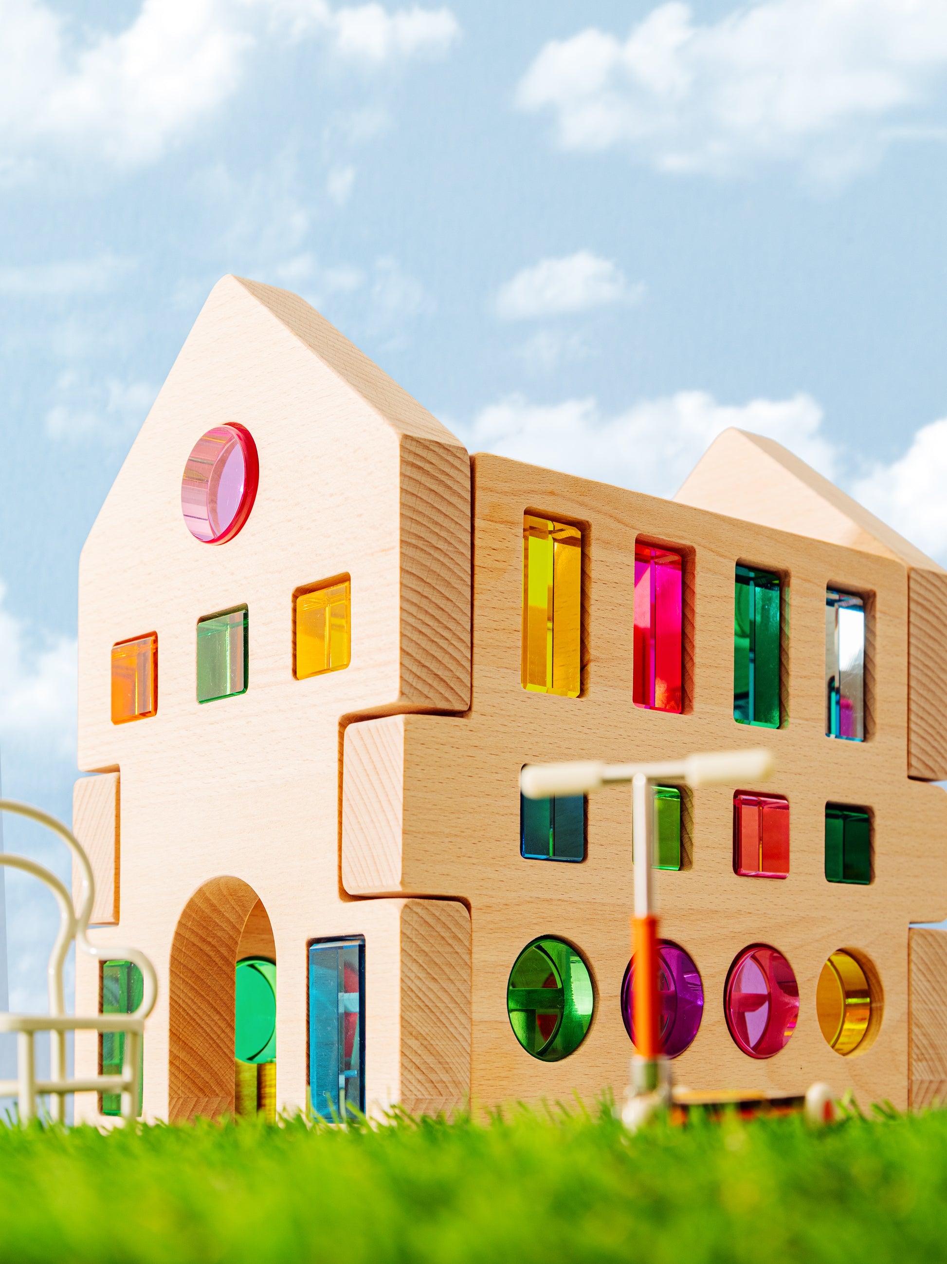 Colorful wooden building from the grand building collection set against a blue sky, promoting imaginative play.