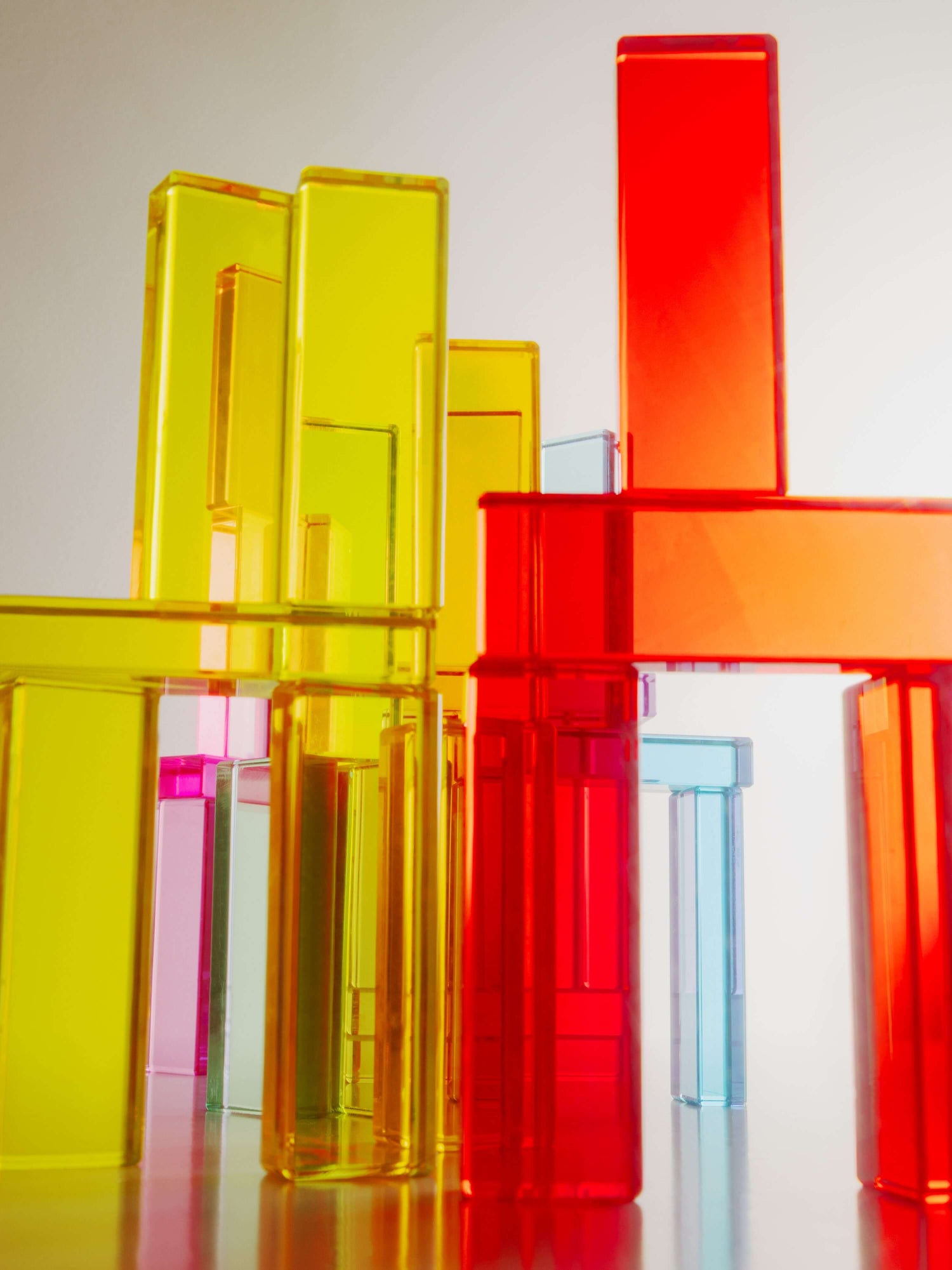 Illume Tower acrylic stacking blocks in bright colors, showcasing light reflection and sensory play.