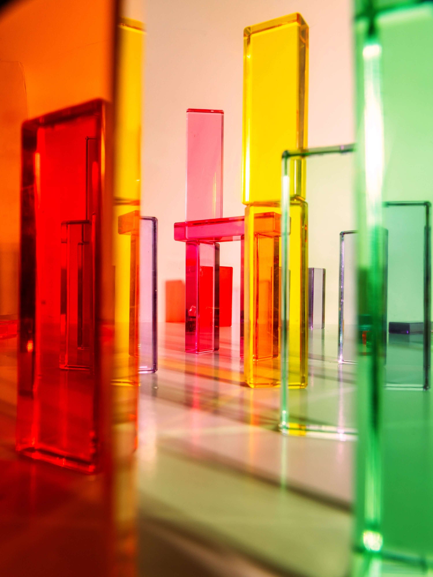 Colorful Illume Tower acrylic stacking blocks in various shapes creating a dynamic play environment.