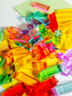 Colorful Illume Tower acrylic stacking blocks scattered on a surface, ready for creative play.
