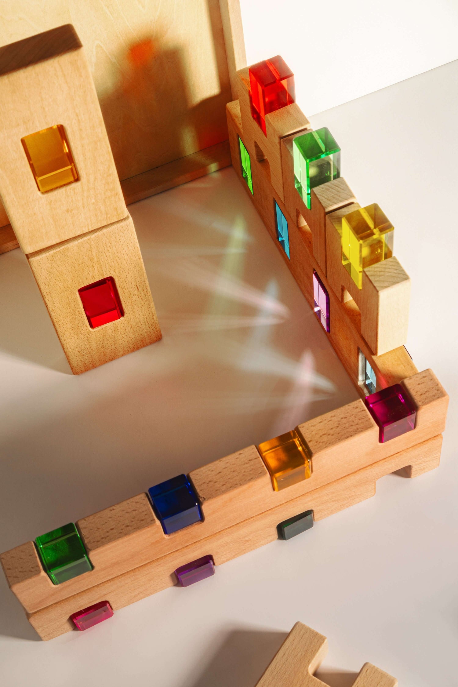 Fynn Set wooden building panels with colorful acrylic inserts, designed for creative play and structural exploration.