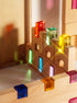 Fynn Set wooden building panels with colorful acrylic window inserts capturing sunlight.