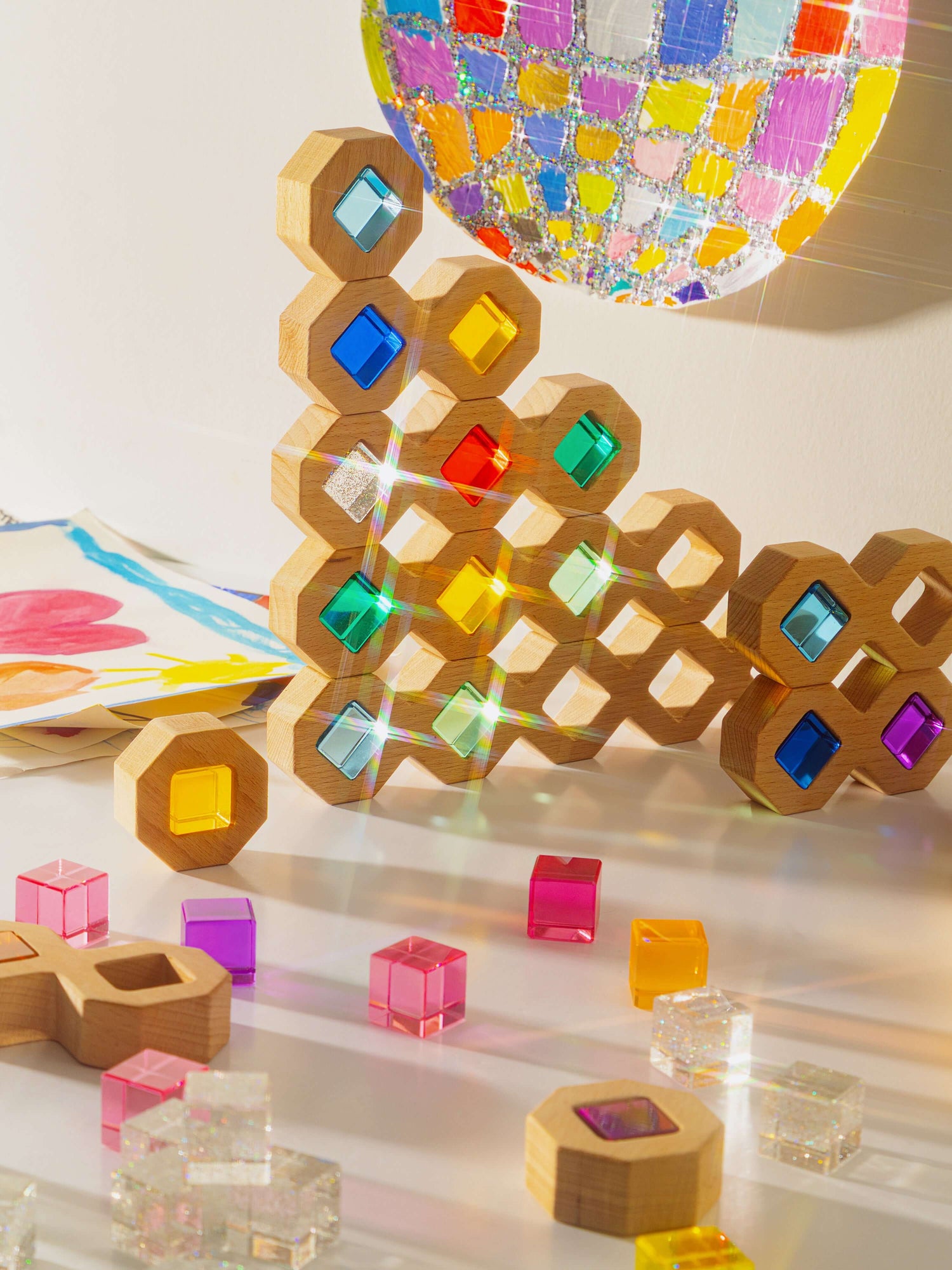Cosmic cube acrylic glitter blocks creating colorful reflections and prisms, perfect for imaginative play.