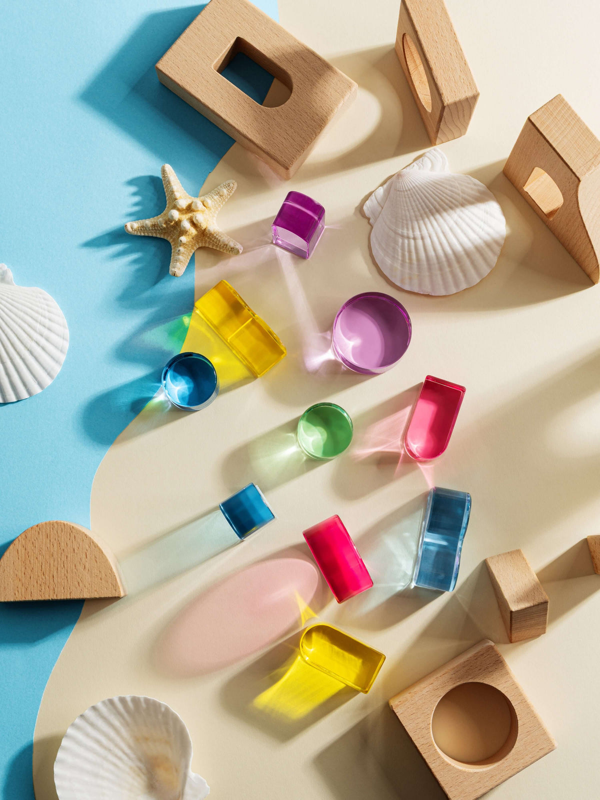 Colorful transparent and beechwood pieces from the Laguna Block Set, arranged for creative play and exploration.