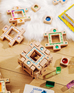 Colorful pieces of the grand building collection set arranged on a wooden surface, showcasing creative play and design.