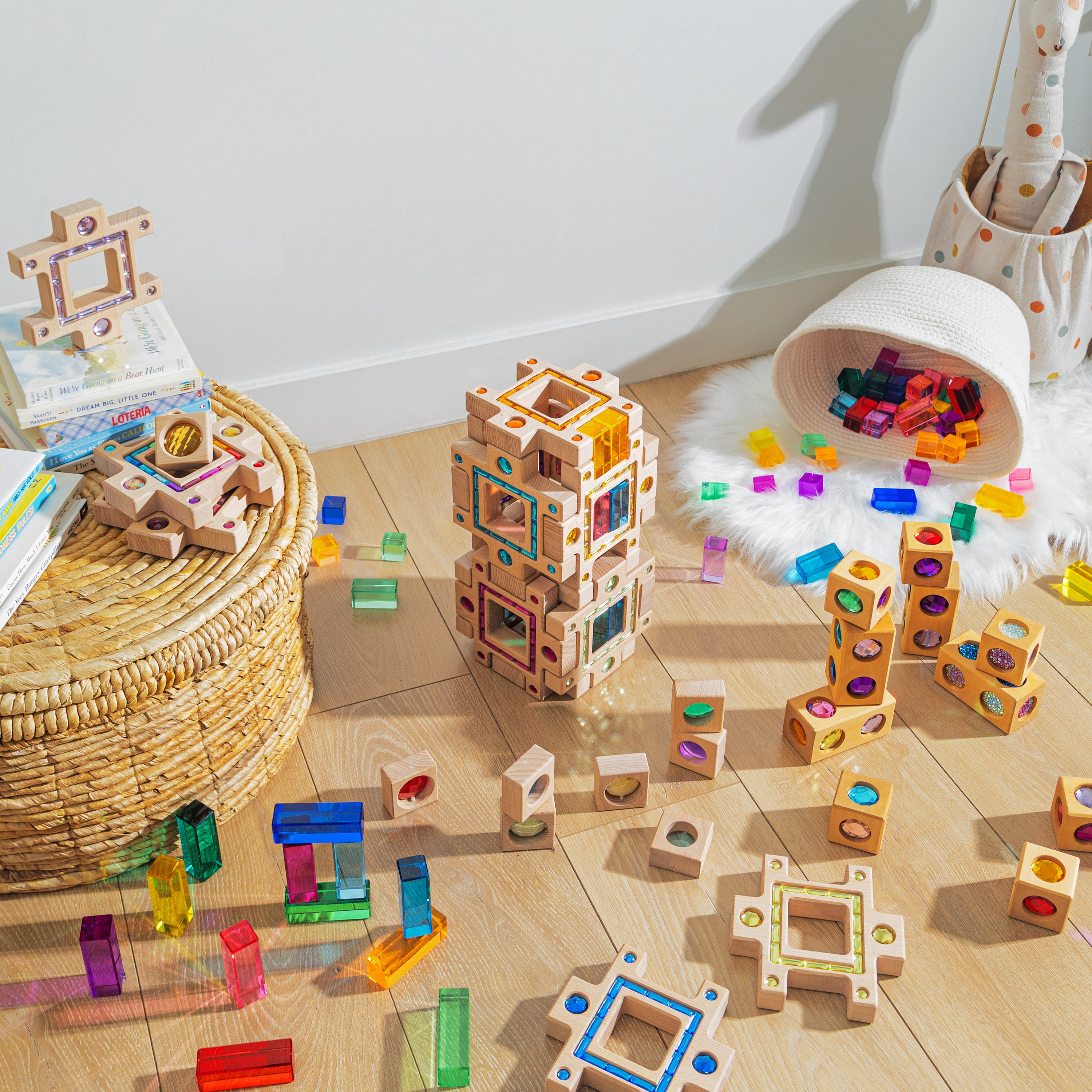 Colorful blocks and building pieces scattered on wooden floor, showcasing the grand building collection set for creative play.