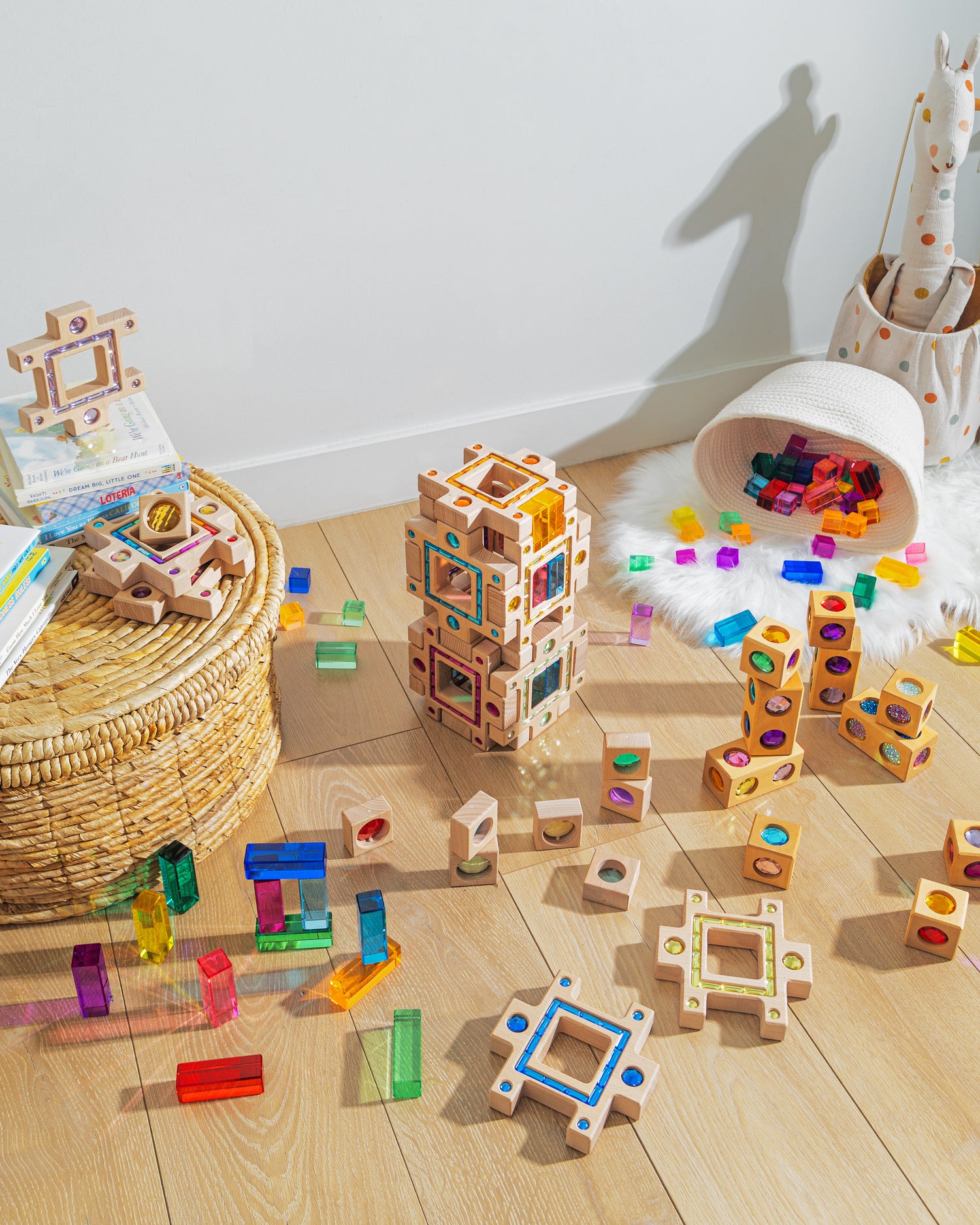 Colorful blocks and building pieces scattered on wooden floor, showcasing the grand building collection set for creative play.