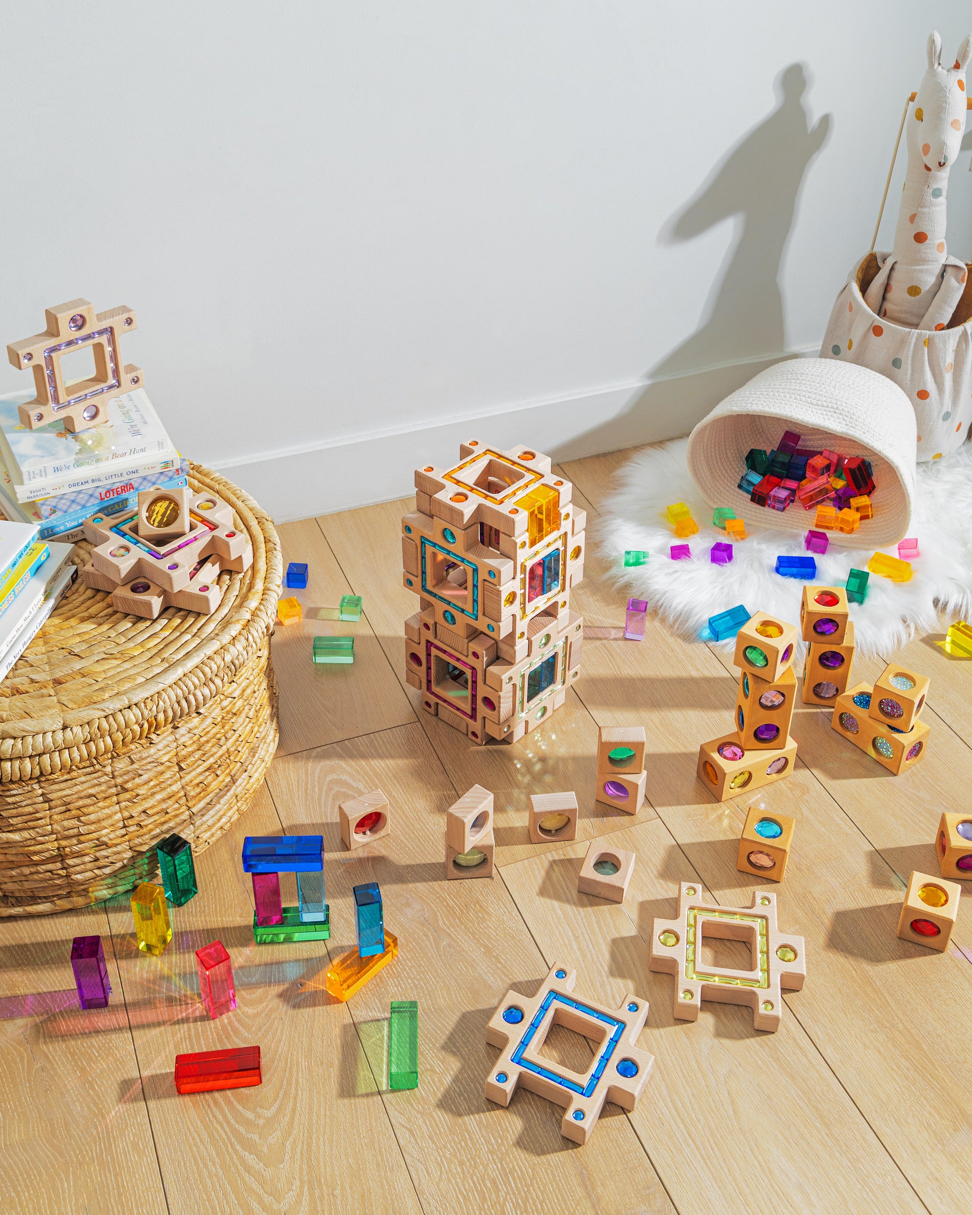 Colorful blocks and building pieces scattered on wooden floor, showcasing the grand building collection set for creative play.
