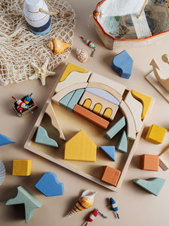 Colorful wooden pieces of the Malibu Puzzle arranged for play, featuring natural wood and non-toxic finishes.