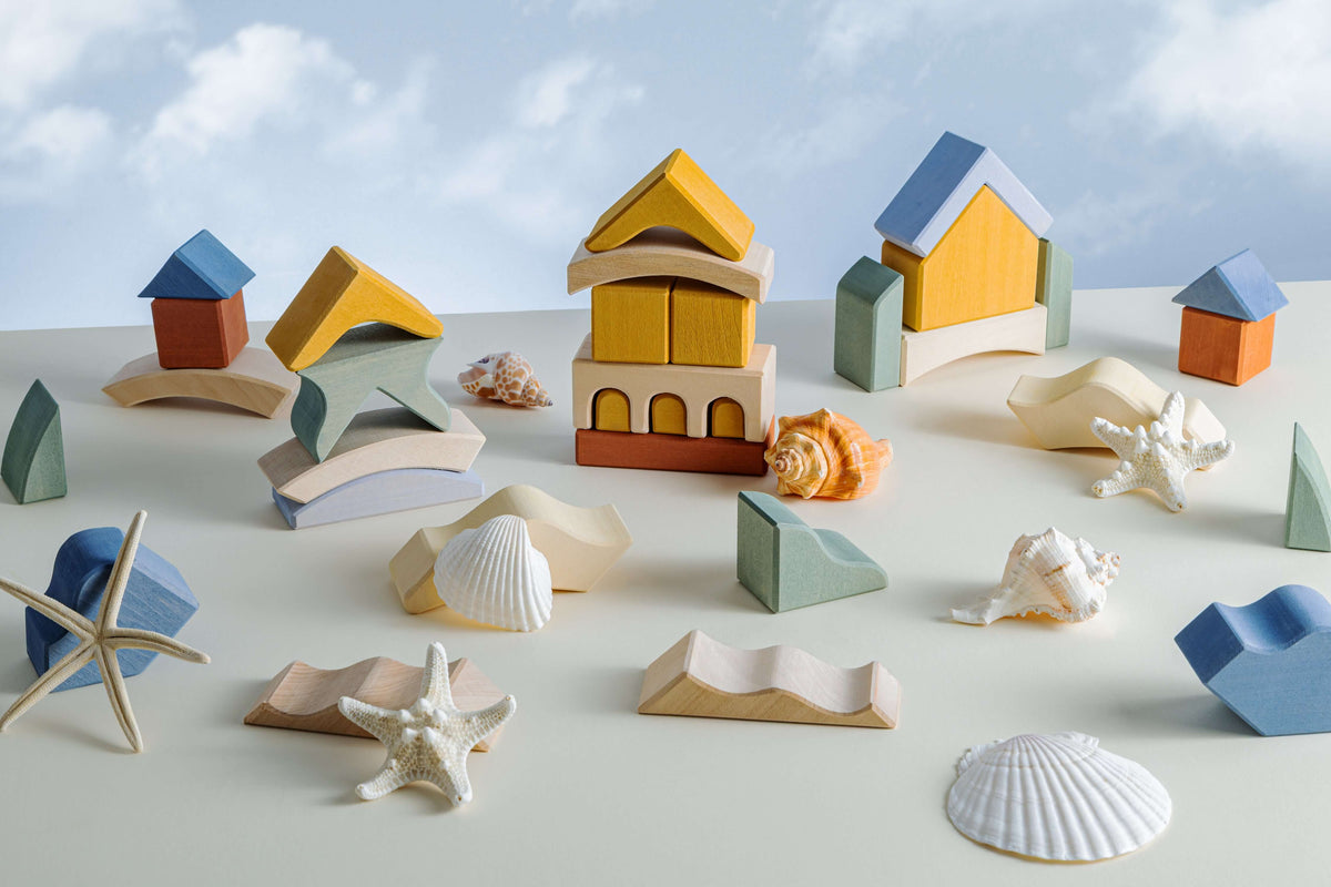Malibu Puzzle pieces featuring colorful wooden blocks and seashells on a light background, perfect for creative play.