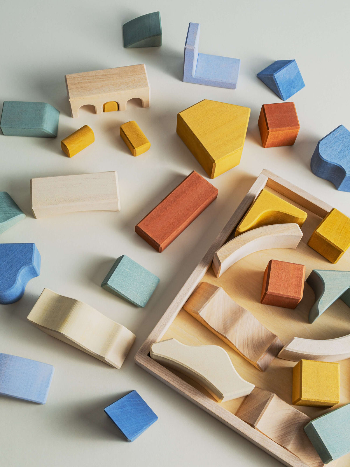 Colorful wooden pieces of the Malibu Puzzle showcase stacking and balancing play.