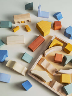 Colorful wooden pieces of the Malibu Puzzle showcase stacking and balancing play.
