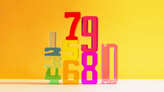 Colorful acrylic Number Blocks arranged in sequence from 1 to 10 against a bright yellow background.