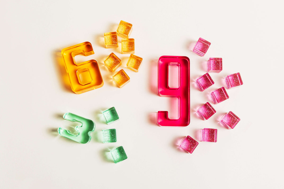 Colorful acrylic Number Blocks representing the numbers 6 and 9 on a light background.