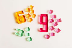 Colorful acrylic Number Blocks representing the numbers 6 and 9 on a light background.