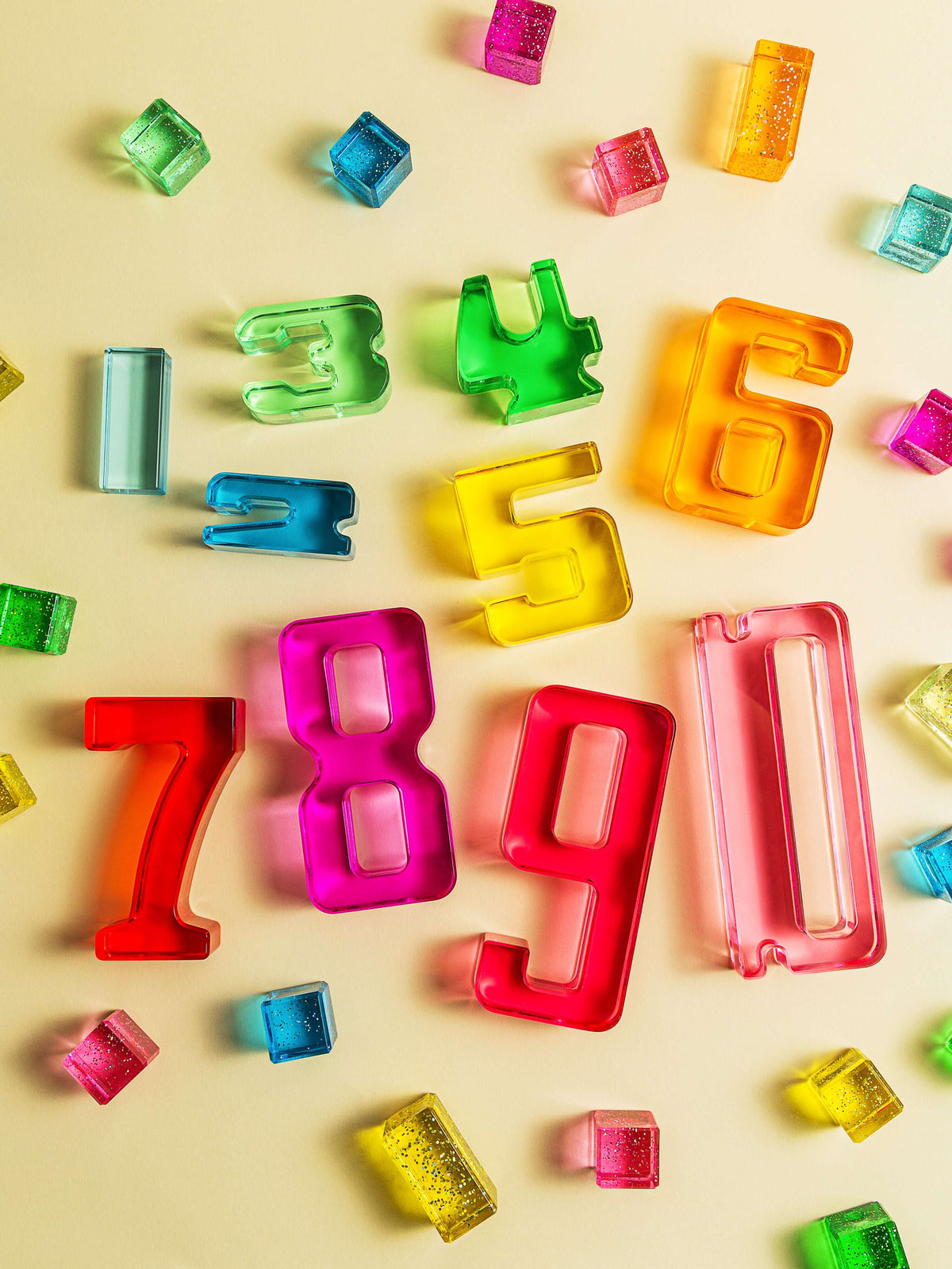 Colorful Number Blocks scattered on a light background, showcasing numbers 1-10 in acrylic design.