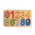 A wooden number puzzle board featuring colorful cutout numbers from 0 to 9 on a light natural wood background, shown against a plain white backdrop.