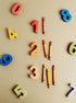 Colorful wooden numbers 0-8 and crayons, highlighting the fun of an educational puzzle set.