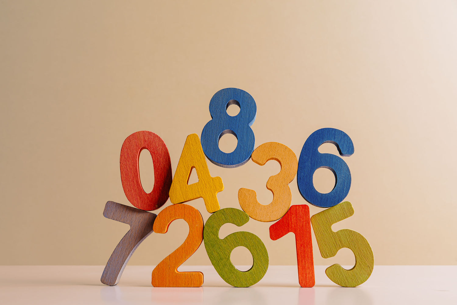 Colorful wooden numbers 0 to 8 arranged playfully, perfect for an educational puzzle set.