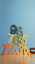 A stack of colorful wooden numbers from 0 to 9 in different colors, arranged on a reflective surface against a solid light blue background.