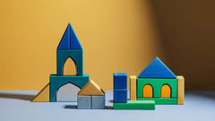 Alex Building Blocks wooden lime wood set with colorful arches, walls, pillars and tunnels arranged as buildings on tabletop