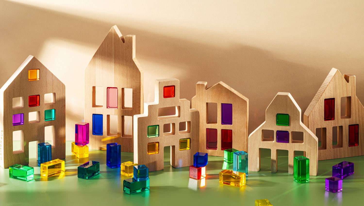 Canal House Blocks wooden houses with colorful translucent details for imaginative play and architecture.