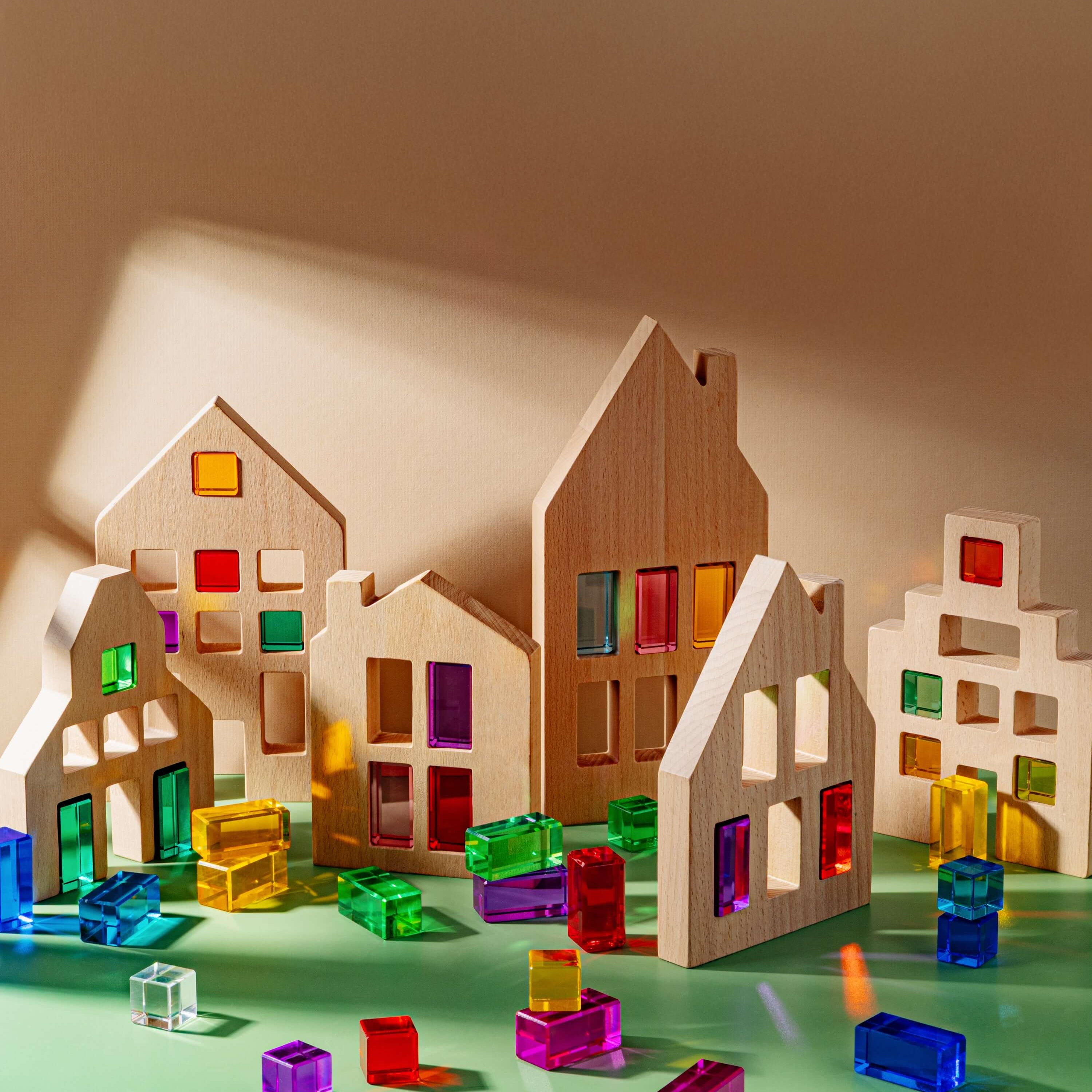 Colorful Canal House Blocks set on a green background with vibrant window cutouts and clear blocks for building play.