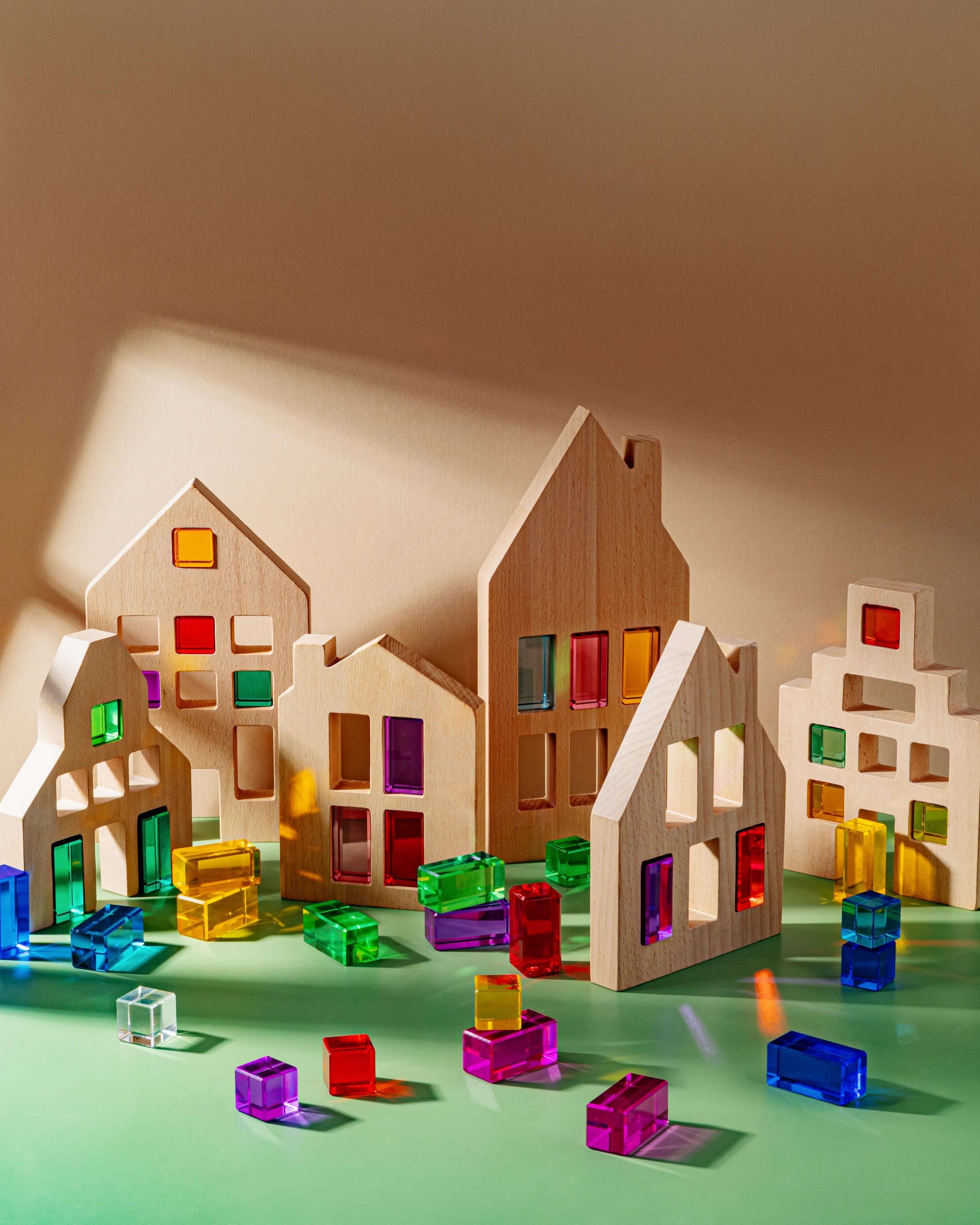 Colorful Canal House Blocks set on a green background with vibrant window cutouts and clear blocks for building play.