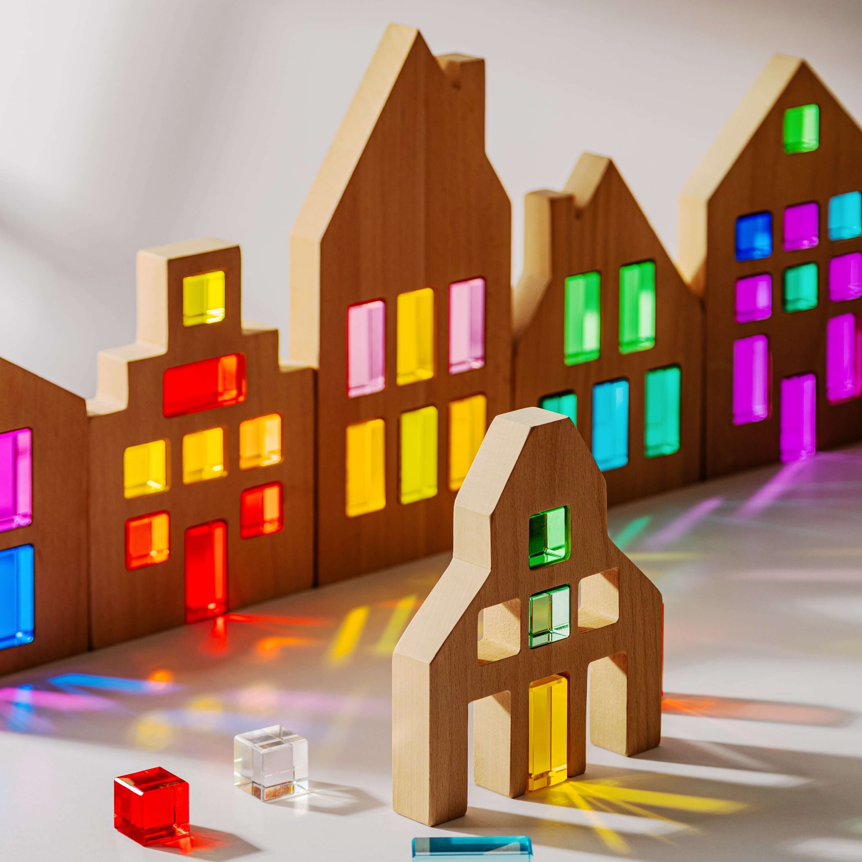 Colorful Canal House Blocks set showcasing translucent acrylic details and wooden houses in various shapes.